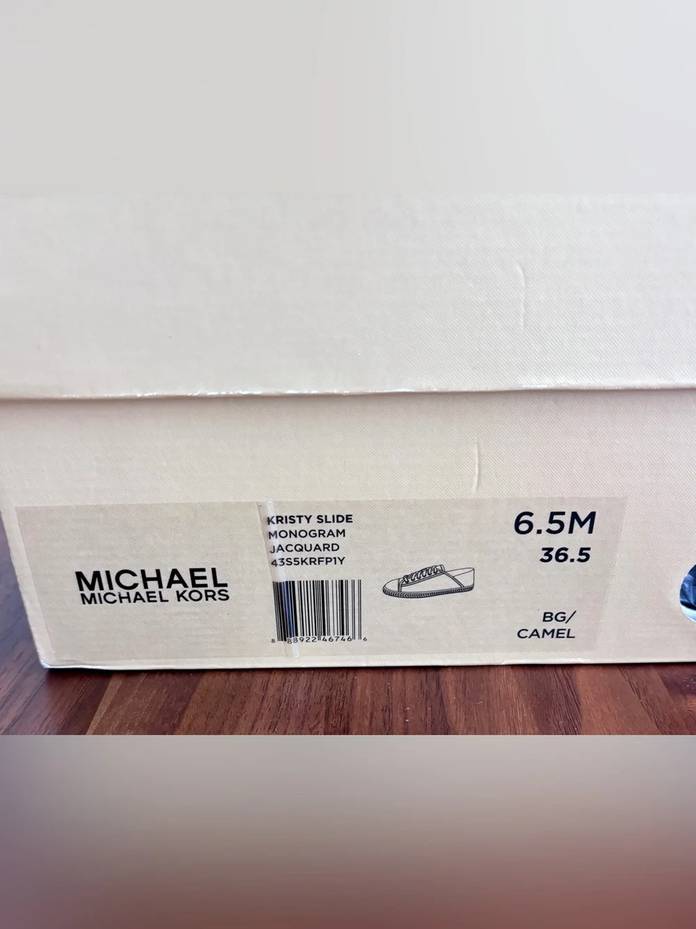 Brand New pair of Michael Kors Kristy Slide Sneakers in a cream and beige, 6.5.